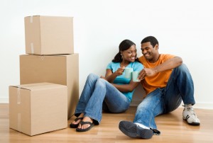 Portrait of couple with boxes.