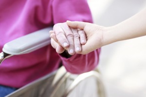 Senior Lady in Wheelchair Holding Hands