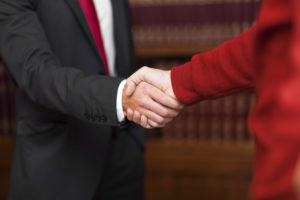 Businessman giving an handshake to a customer
