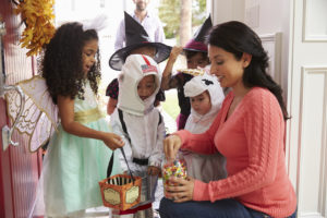 Children In Halloween Costumes Trick Or Treating